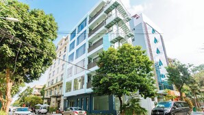 A multi-story building with balconies, large windows, and a modern architectural style. - Wake Up to Sunshine in Ninh Binh's Old Quarter - Cozy 2BR for Families! (Hoa Lư)