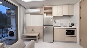 A compact kitchen with a built-in air conditioner, a stainless steel refrigerator, a sink, and a dishwasher. - Relax in Kamala | Rooftop Pool, Gym  | B606 (Tambon Kamala)