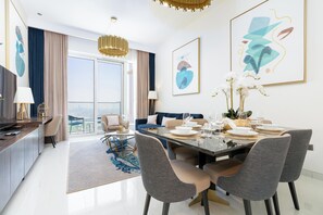 Luxury Apartment, Golf View | Living area | 65-inch flat-screen TV with satellite channels - bnbme - Avani - 2BR (Dubai)