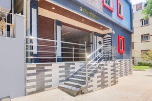 A building with a staircase leading to a covered entrance, a sign reading 'Sri Rajah Muralay,' and a modern design with a mix of materials. - Classic Sri Balaji Luxury Rooms (Hyderabad)