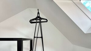 A room with a black metal floor lamp, a white radiator, and a window with a black blind. - Doux nid Perche Avec vue Magique sur la Ville (Brussels)