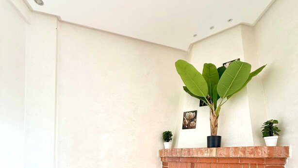 A corner room with a brick fireplace, wooden flooring, and a potted plant on the mantel. - Villa With Pool Rooftop Near Amelkis and Al Maaden Golf Courses Route de Ouarzazate Area (Marrakech)