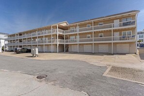 A multi-story motel with balconies, a parking area, and a storm drain. - ✨Walk 2 Beach~ Jetty Retreat✨ (Destin)