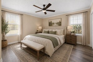 A bedroom with a bed, bedside tables, a bench, a ceiling fan, and a window with curtains.