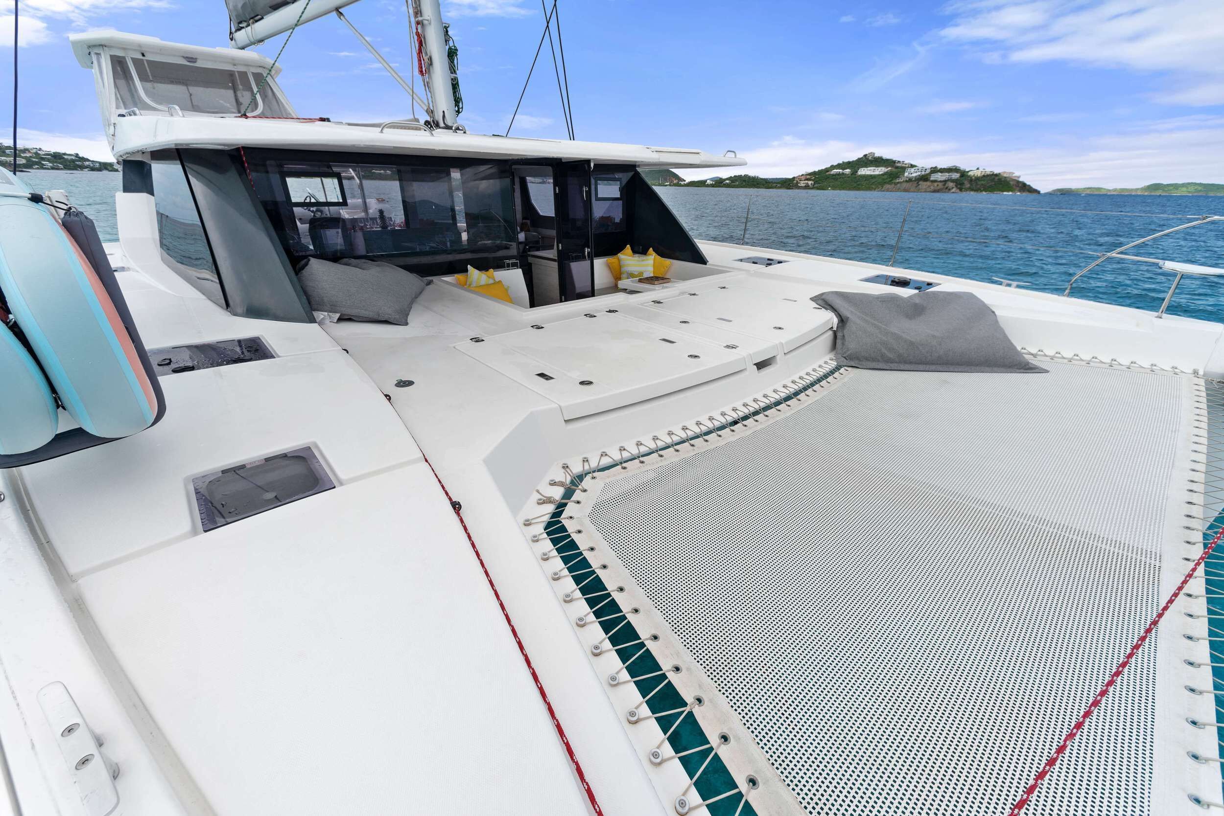 A boat deck with seating, a control station, and a view of the water.