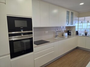 Fridge, microwave, oven, stovetop - Modern Beachfront 2BR with Terrace, A/C, WiFi & Garage in top location (Quarteira)