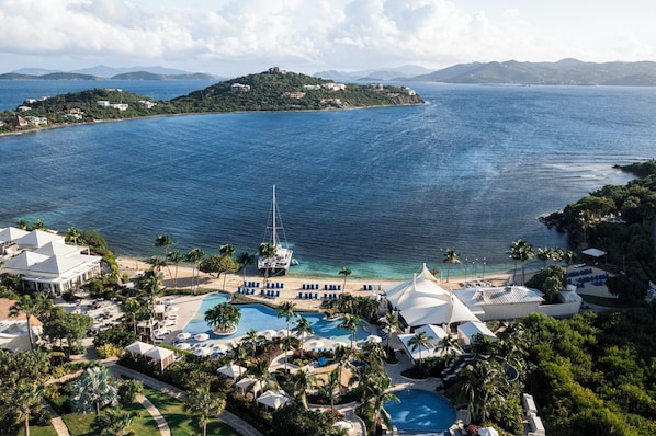 A resort with a large swimming pool, beach area, and a sailboat. - Luxury Ritz Carlton Spacious 3-bedroom condo Top Floor in beautiful St Thomas (St Thomas)