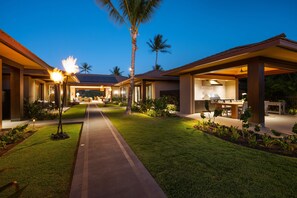 Ein modernes Resort mit einem zentralen Weg, Außenbestuhlung und einem überdachten Essbereich.