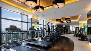 A modern gym with treadmills, exercise bikes, and free weights. - The Gramercy Residences-58th floor w/balcony+Skyline view (Makati)
