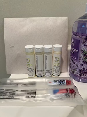 Four bottles of body wash, a bottle of lavender-scented soap, and a package of dry face wipes on a table. - 1 FREE parking spot - Coolidge Corner-Close to T (Brookline)