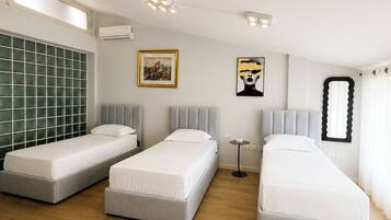 Exclusive Triple Room, Garden View | Minibar, in-room safe, desk, blackout drapes