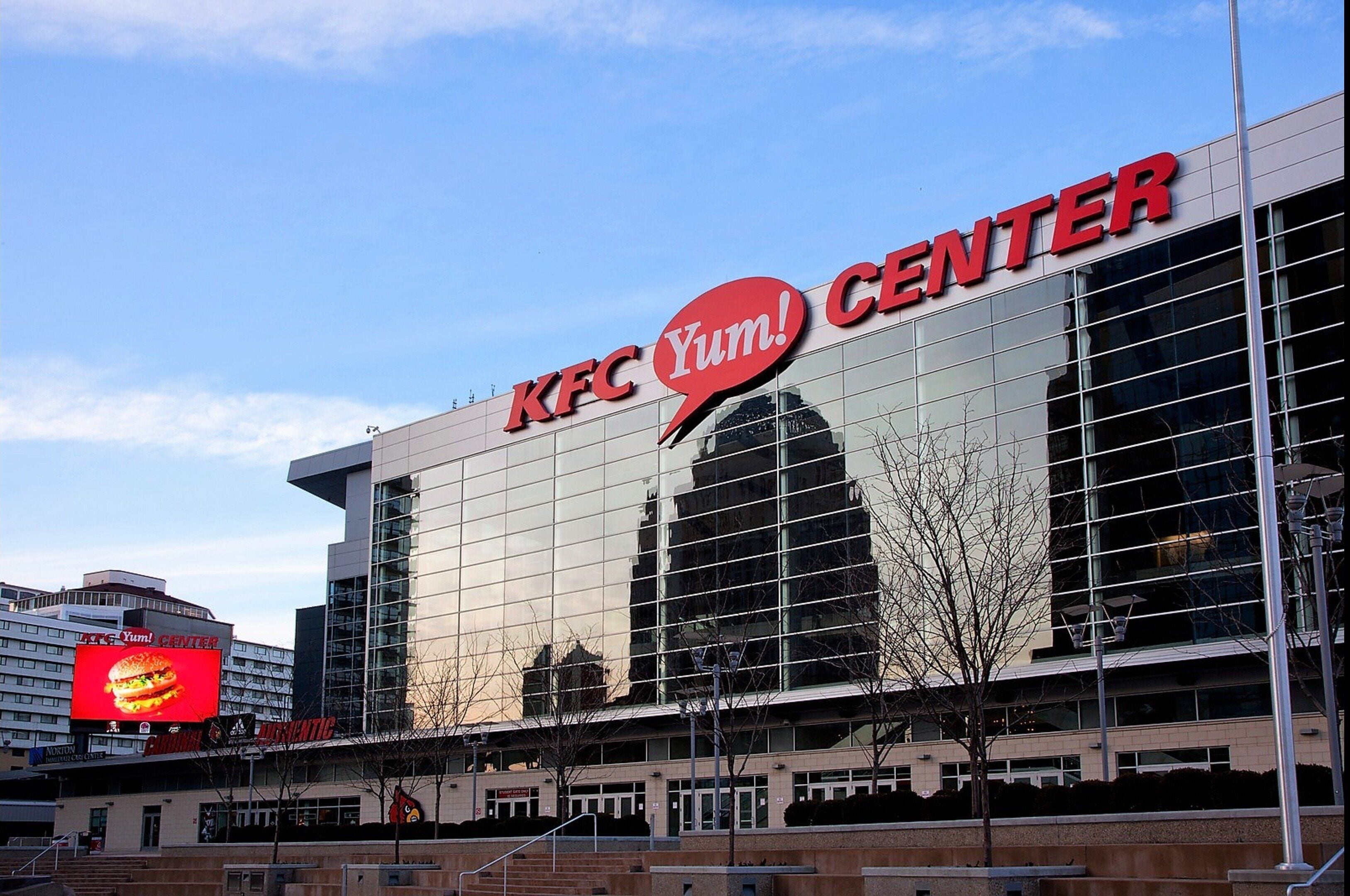 A KFC Yum! Center with a large glass facade and a prominent red logo.