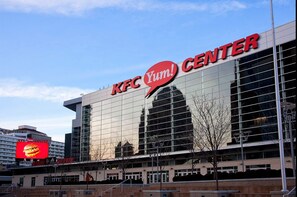 A KFC Yum! Center with a large glass facade and a prominent red logo. - Candlewood Suites Louisville Fair Expo Center by IHG (Louisville)