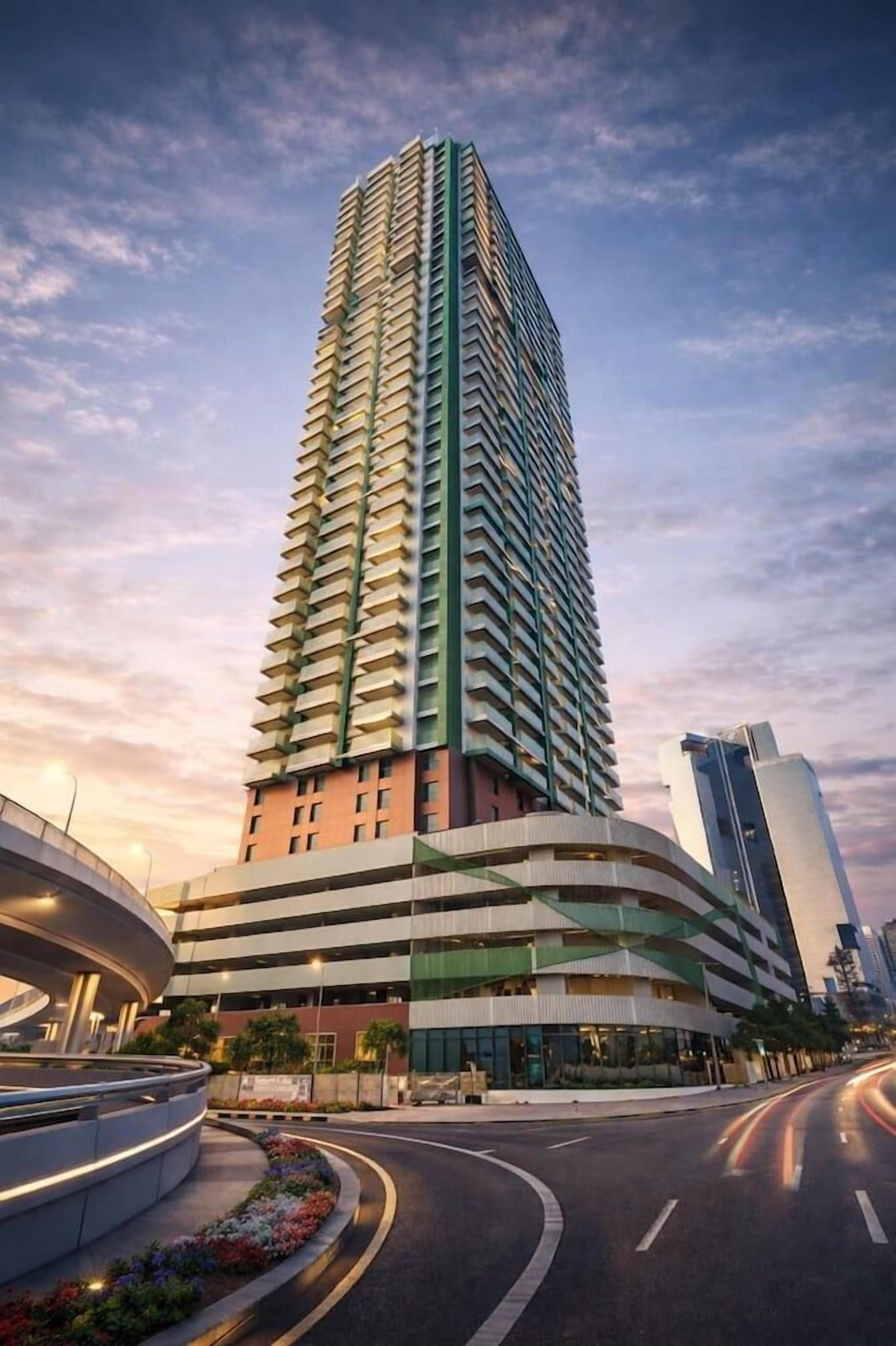 A high-rise building with a curved facade, multiple floors, and a modern architectural design.