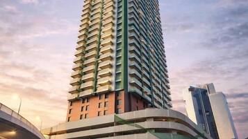 A high-rise building with a curved facade, multiple floors, and a modern architectural design.