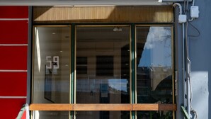 A building entrance with a glass door, a number '59' on the door, and a staircase leading up. - Artline Residence in Acropolis District (Athens)