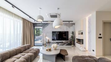 Luxury Villa, Balcony, Sea View | Living area | 55-inch flat-screen TV with cable channels, books