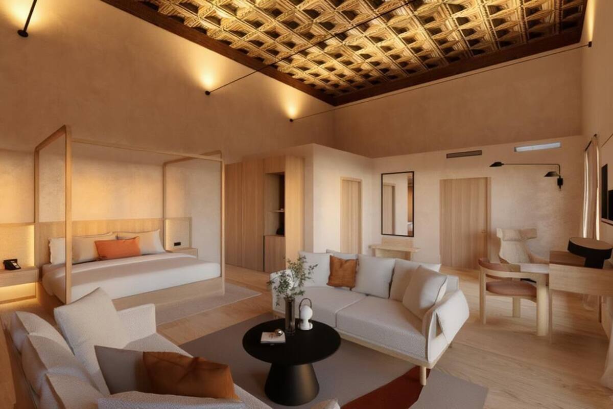 A modern living room with a sofa, a coffee table, and a dining area with a chair.