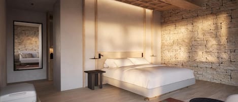 A modern bedroom with a large bed, a stone accent wall, and a minimalist design.