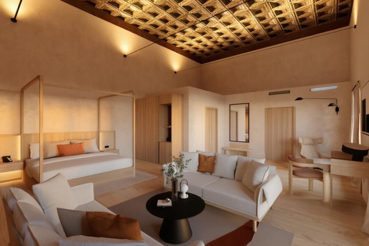 A modern living room with a sofa, a coffee table, and a dining area with a chair.