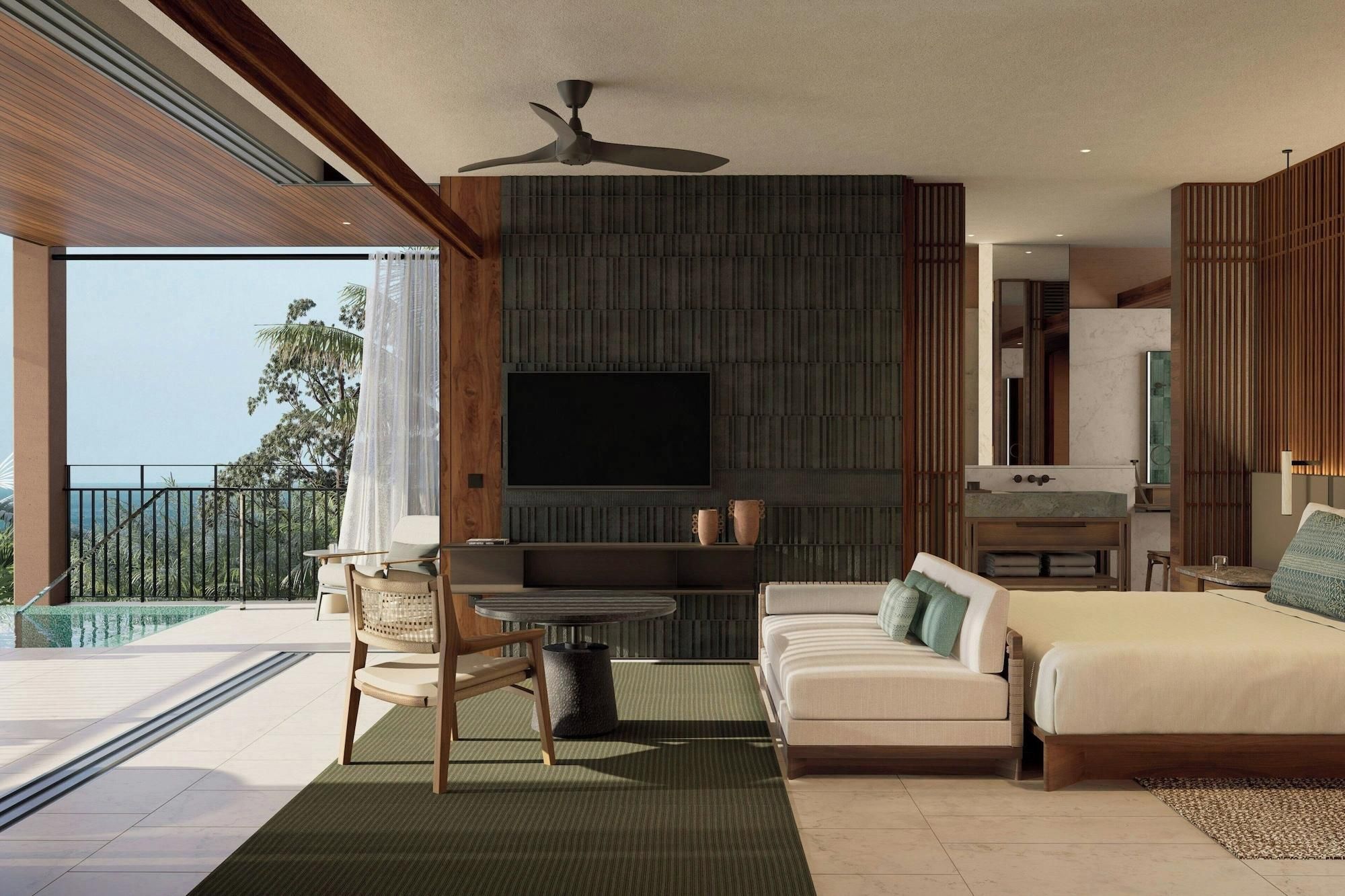 A modern hotel room with a balcony, a flat-screen TV, a sofa, a bed, and a small table.