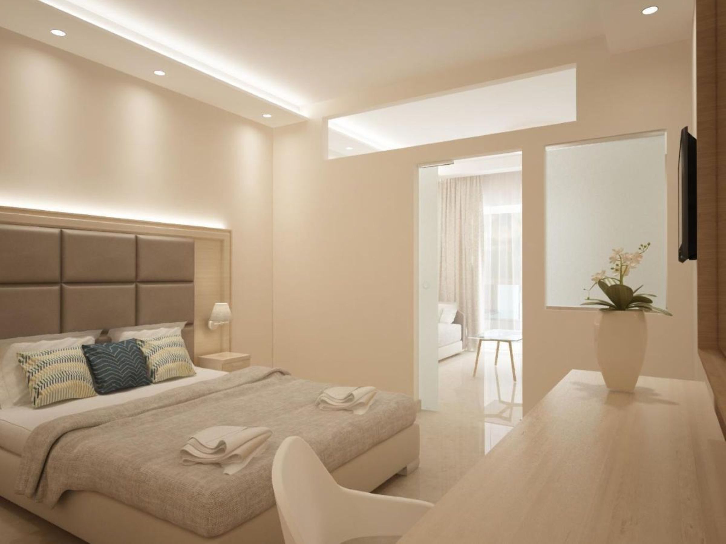 Habitación de hotel moderna con cama, mesita de noche, lámpara y vistas al área de estar contigua.