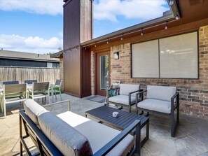 An outdoor patio with a sofa, chairs, and a table. - Texan Hideaway - Cozy, Convenient, Comfortable! (Lewisville)