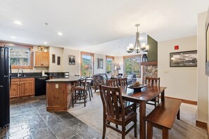 Una cocina amplia con comedor, armarios de madera y una isla grande.