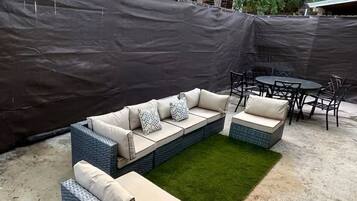A sectional sofa with multiple seating areas and a small table with chairs.