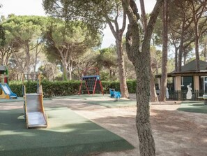 A playground with a slide, swing set, and climbing frame. - Studio in Saint-Raphaël: Pool & Tennis (Saint-Raphaël)