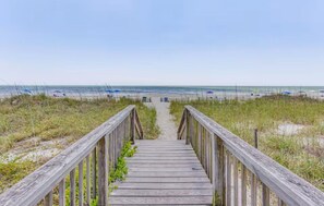 A wooden boardwalk leading to a beach with a clear view of the ocean. - Ocean Forest Villas-Beach-Pools! (Myrtle Beach)