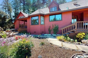 A red two-story house with a porch, large windows, and a well-maintained garden. - Dog-Friendly Sebastopol Pool Home & Spa with Hot Tub (Sebastopol)