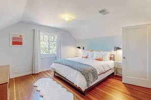 A bedroom with a bed, a window, a door, and a ceiling light. - Healdsburg 5BR Fitch Mountain cottage with river valley views (Healdsburg)