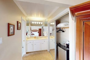 A hotel bathroom with a large mirror, a vanity with a sink, and a walk-in closet with a mirror. - Napa Silverado studio with golf & Atlas Peak views, pool access (Napa)