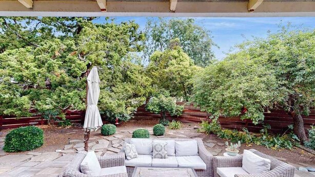 An outdoor patio with wicker furniture, a table, and a pergola. - Renovated Wine Country Ranch w/ Private Patio & AC - Sleeps 4 in Santa Rosa (Santa Rosa)