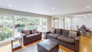 A spacious living room with large windows, a sofa set, a coffee table, and a dining area. - Renovated Wine Country Ranch w/ Private Patio & AC - Sleeps 4 in Santa Rosa (Santa Rosa)
