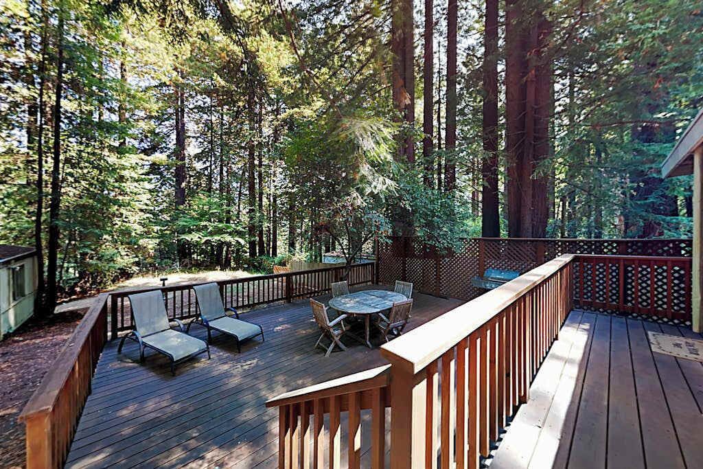 Settle into your private redwood canopy deck — lounge chairs and a dining set await your morning coffee among the towering trees of Cazadero.
