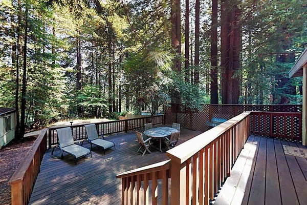 Settle into your private redwood canopy deck — lounge chairs and a dining set await your morning coffee among the towering trees of Cazadero.