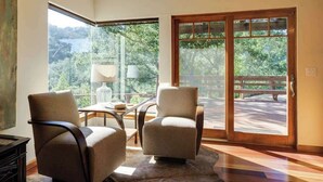 A room with two chairs, a table, and a large sliding glass door leading to an outdoor area. - Wine Country Home w/ Solar-Heated Pool, Hot Tub & Mountain Views | Sleeps 8 (Santa Rosa)