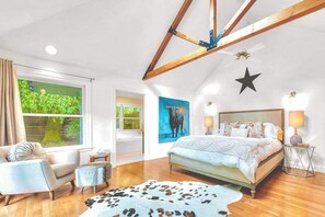 A bedroom with a bed, a window, a star decoration, and a painting. - Zegarra Estate -- 6-acre Sonoma wine country compound, sleeps 14 across two homes (Sebastopol)