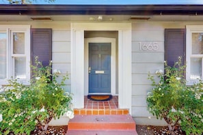 A house with a front door, number 1665, and a small set of steps leading up to it. - Santa Rosa 2BR home with shaded patio — walk to Willi's Wine Bar (Santa Rosa)
