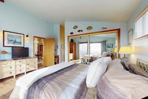 A bedroom with a large bed, a television, a wardrobe, and a mirror. - Bodega Bay 3BR hilltop home with panoramic ocean views & wraparound deck (Bodega Bay)