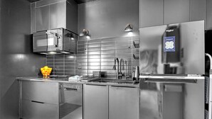 A modern kitchen with stainless steel appliances, a dishwasher, and a microwave. - UNIQUE Oceanside Escape 19 (Cocoa Beach)