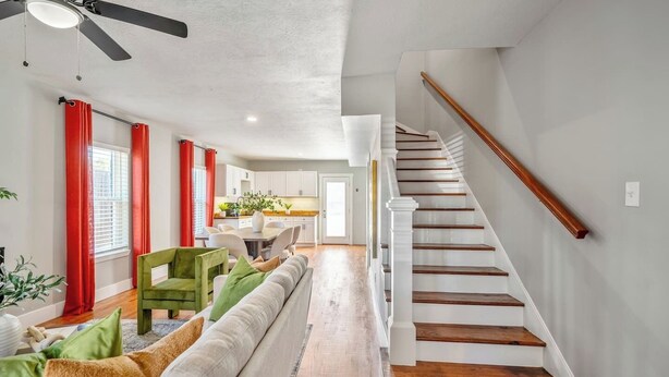 A modern interior with a staircase, a dining area, and a living room. - Spacious 2BR Home with King Beds Near Downtown, WiFi, Parking & Easy Self Check-In (Houston)
