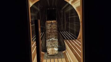 A sauna with a wooden interior and a glass enclosure.