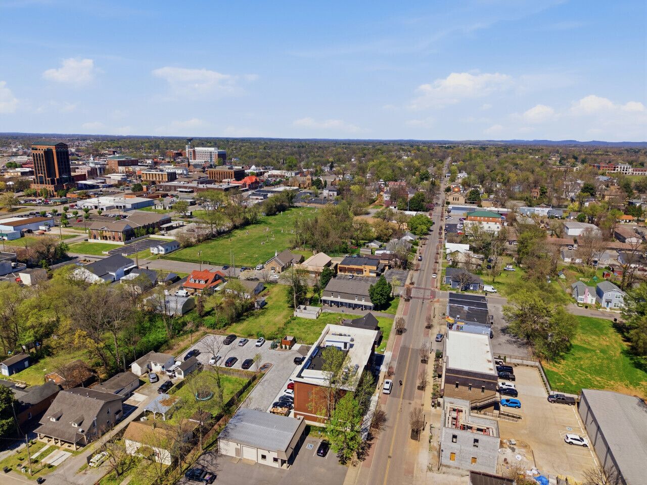 An aerial view of a residential area with houses, streets, and a few commercial buildings.