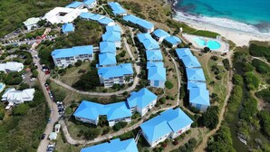 An aerial view of a resort with multiple buildings, a beach, and a pool. - Studio Hotel Mont Vernon - sea view (Orient Bay)