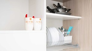 A kitchen with white cabinets, a dish rack, and two containers labeled 'ALMARE Bed & Breakfast.' - Monolocale Alba Salentina Nuovo, Elegante e Vicino al Mare (Nardò)