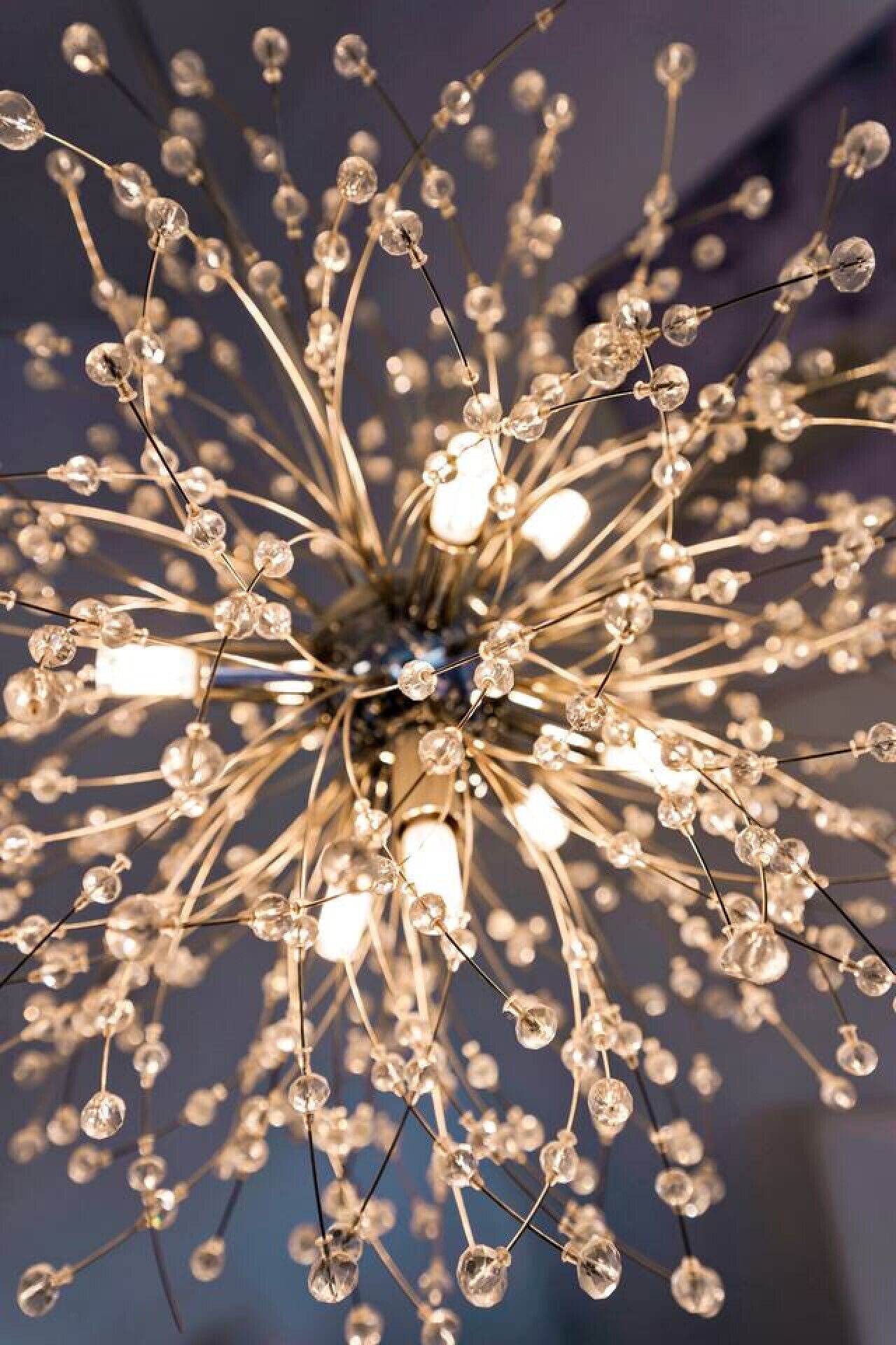 A chandelier with multiple light bulbs and clear glass elements.
