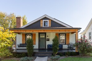 A two-story house with a front porch, a chimney, and a small garden. - The Storybook Cottage | Close to Lancaster | Secret Room (Lancaster)